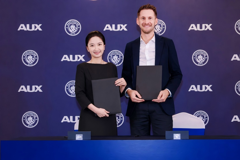 AUX and Manchester City representatives at the partnership signing ceremony
